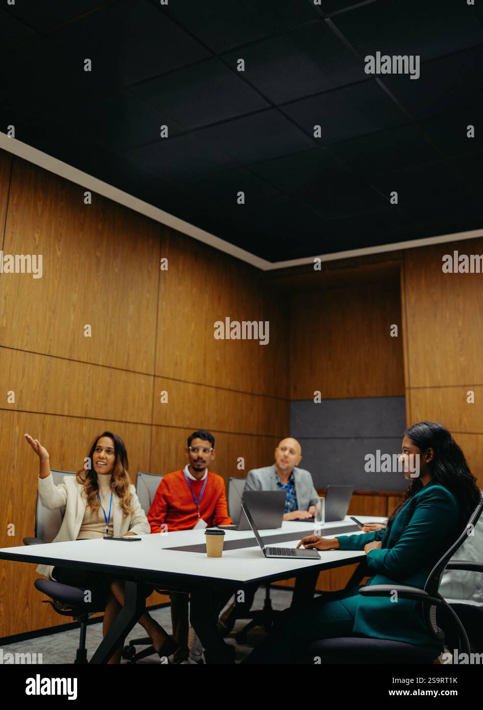 A diverse group of professionals is engaged in a collaborative business ...