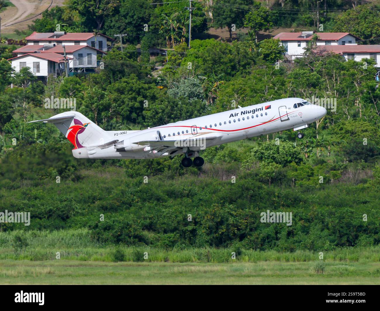 Air Niugini Fokker F70 aircraft taking off. Airplane Fokker 70 of Air Niugini from Papua New Guinea. Fokker F70 plane. Stock Photo