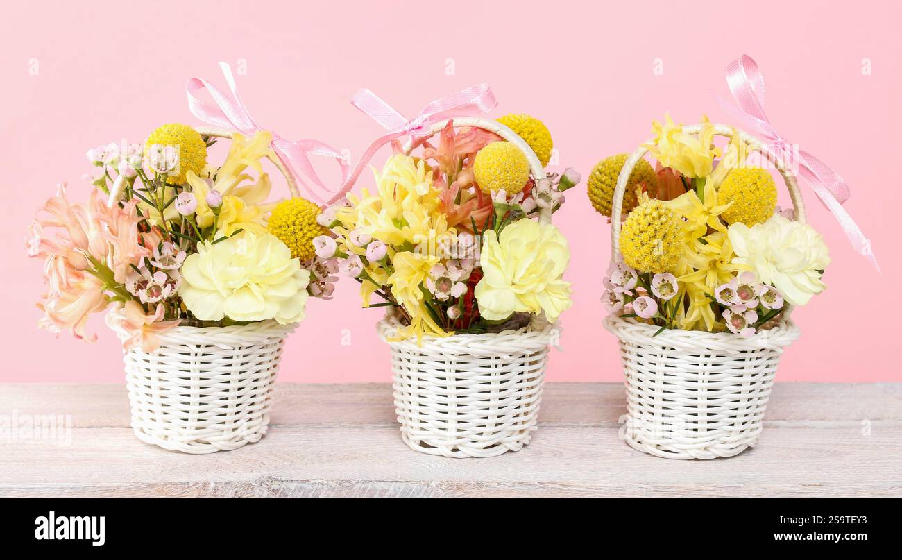 Three tiny baskets with flowers. Party decor Stock Photo