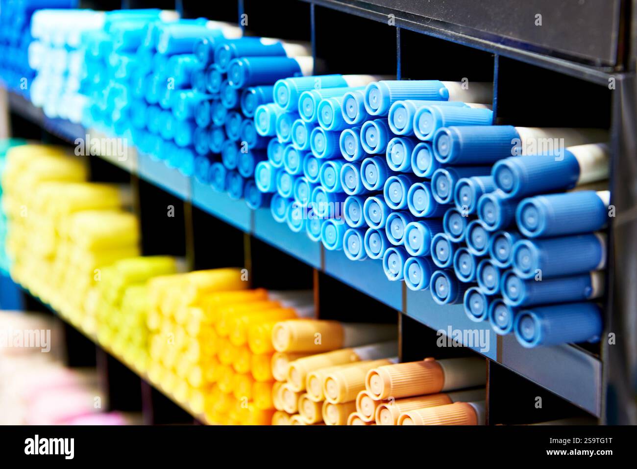 Colored blue yellow markers on a store shelf Stock Photo