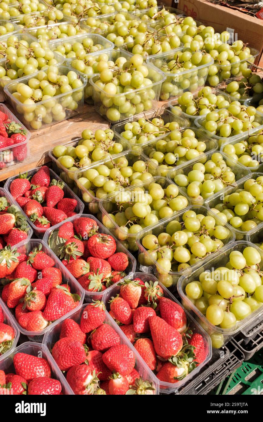 Punets strawberries  and grapes on sale,UK Stock Photo
