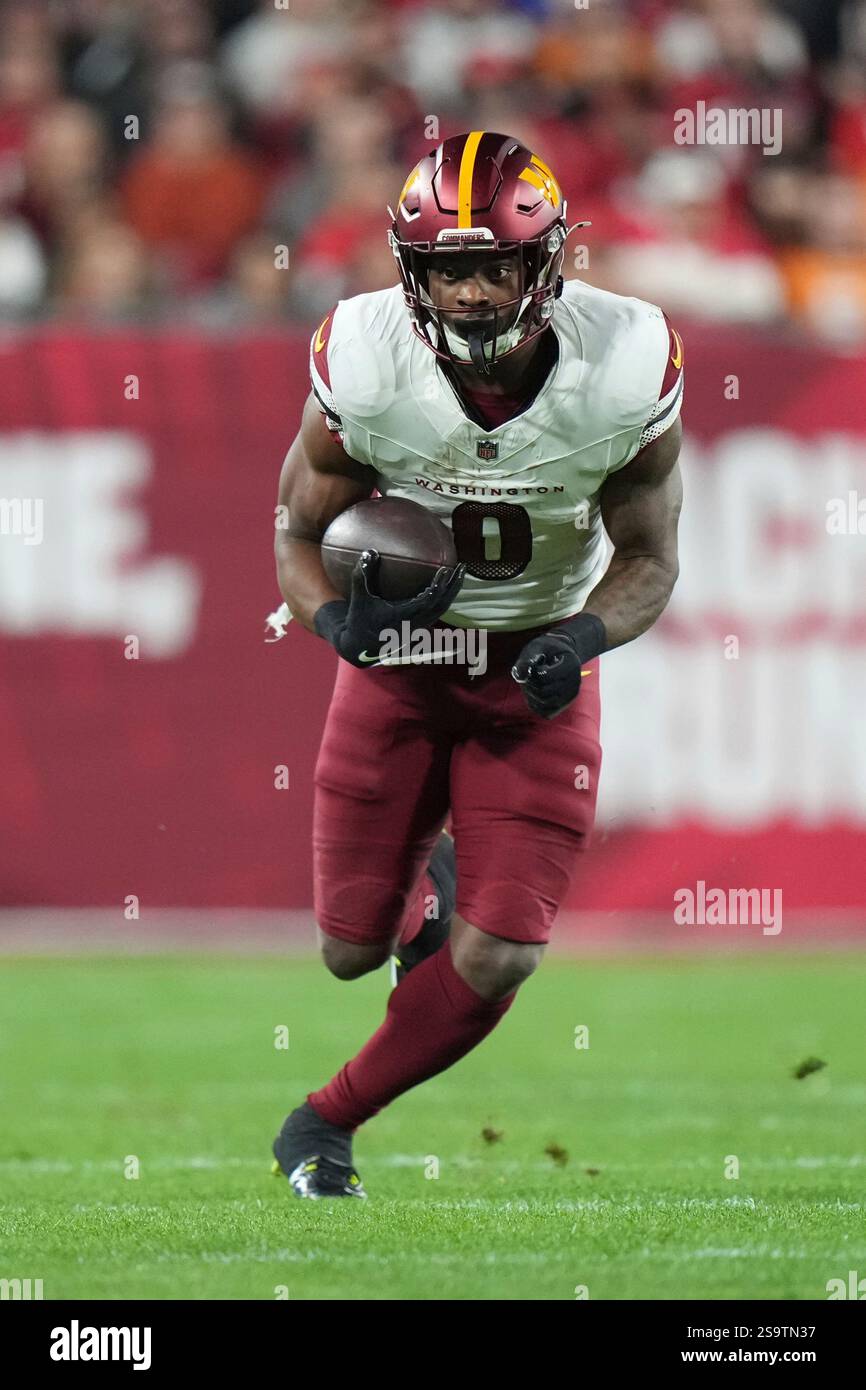 Washington Commanders running back Brian Robinson Jr. (8) runs after a