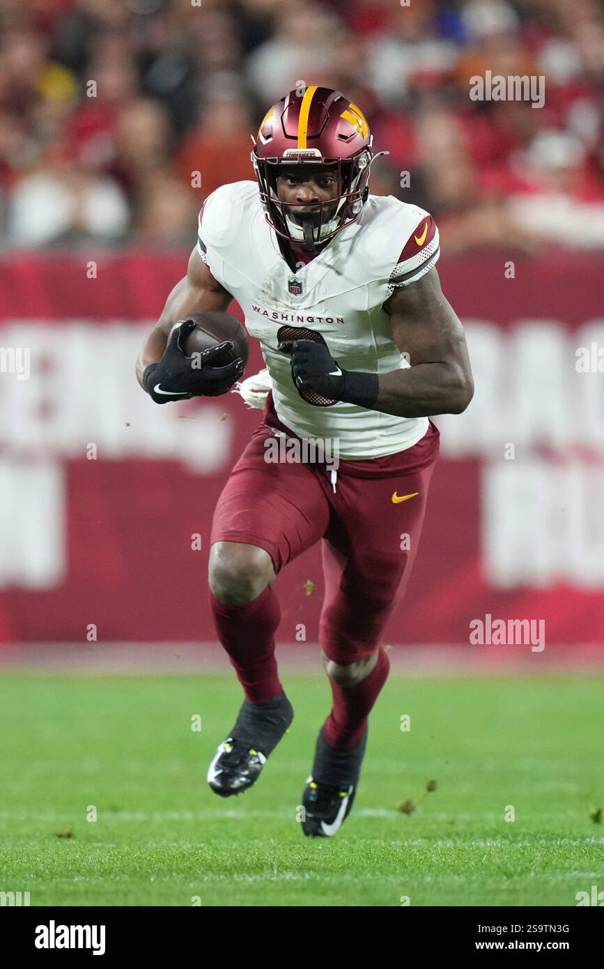 Washington Commanders running back Brian Robinson Jr. (8) runs after a