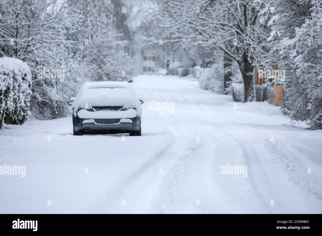 Snow-covered road and car covered in snow, road conditions in winter ...