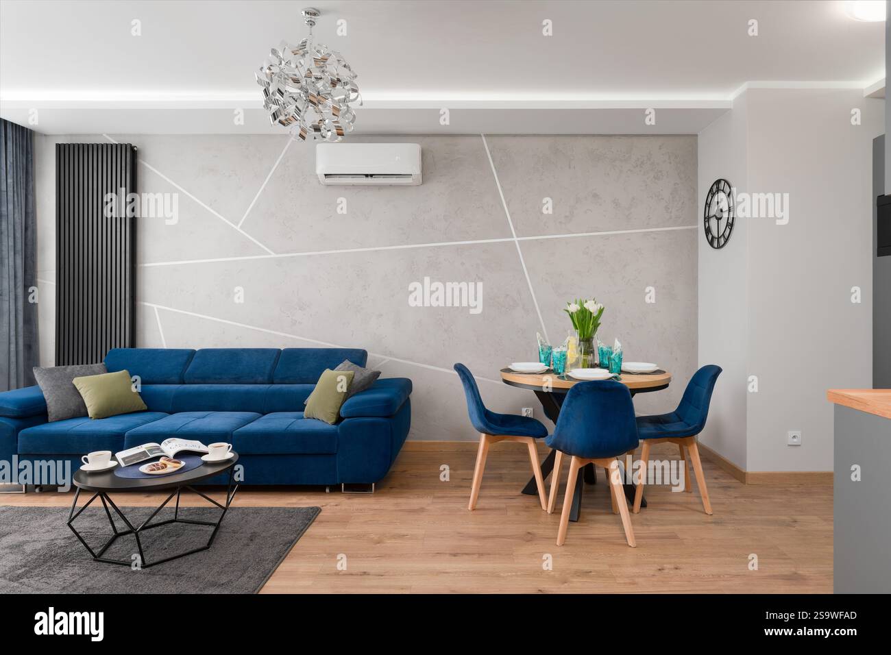 Modern Apartment with Blue Sofa and Dining Area Stock Photo