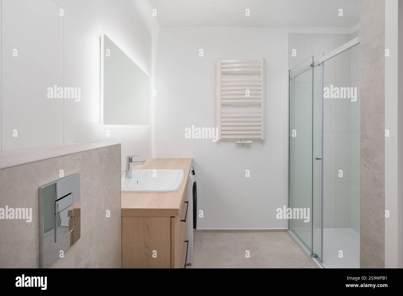 Bright Modern Bathroom with Shower and Lighted Mirror Stock Photo