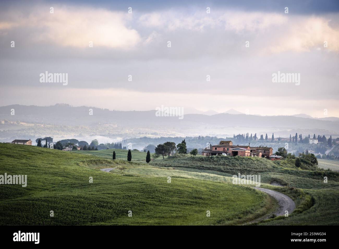 Tuscan Farmhouse on a Hillside with Misty Valley View Stock Photo - Alamy