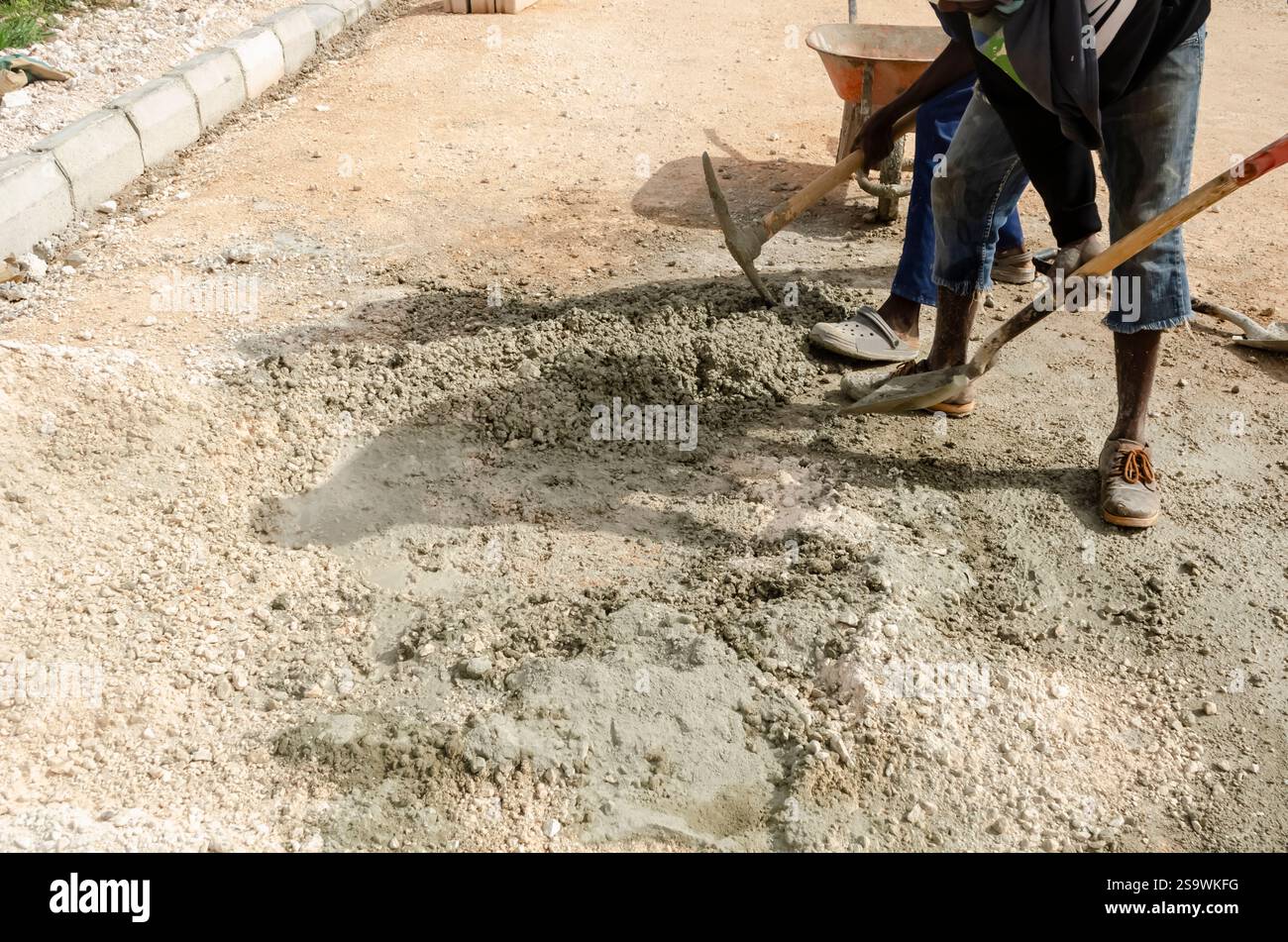 Men using tools to mix marter on construction site. Stock Photo
