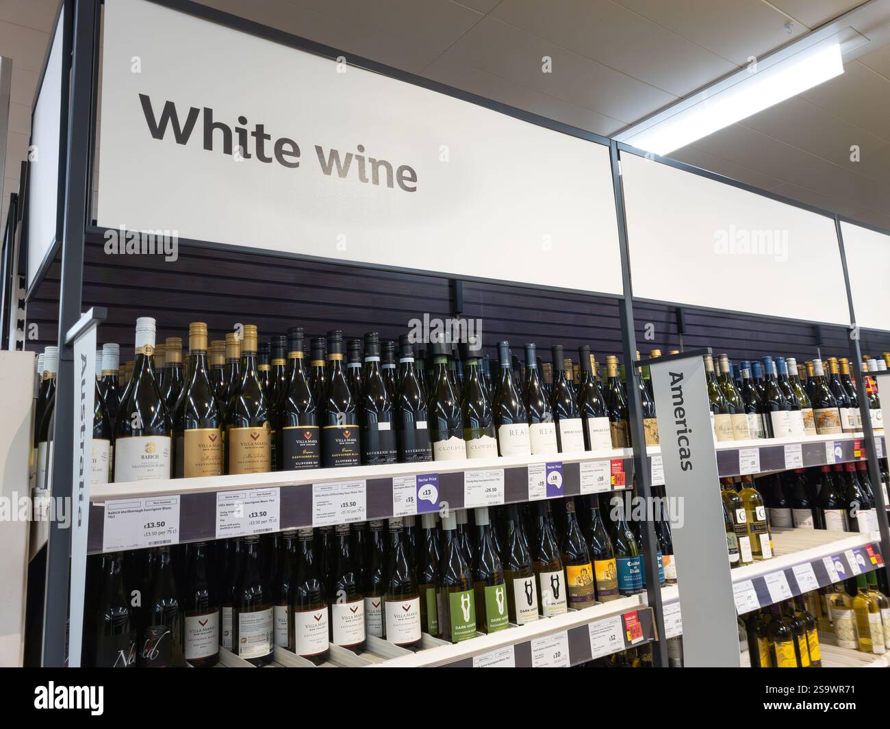 White wine aisle in a Sainsbury's supermarket, with wine bottles from different countries, UK. Concept: cost of living, alcohol sales, shoplifting - Smartphone Captured Stock Image