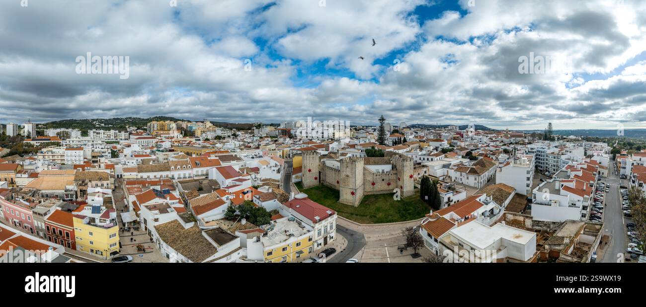Aerial view of Loule castle in Algarve Portugal, three outward projecting square towers with Christmas star decoration and Portuguese flag Stock Photo