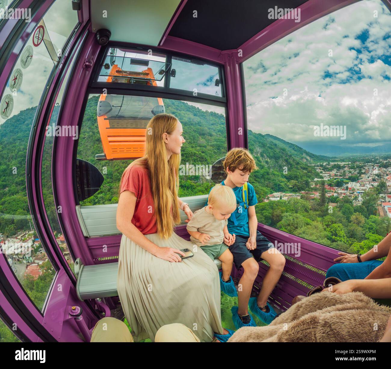 Mother and two sons on a cable car ride in Orizaba, Mexico. Scenic ...