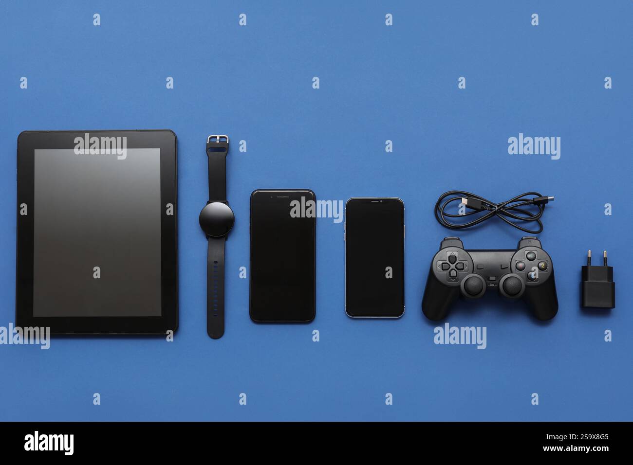 Composition with different modern gadgets on blue background Stock Photo