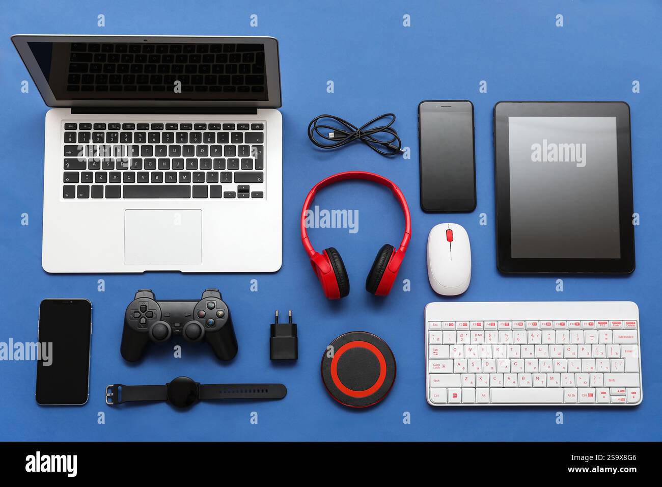 Composition with different modern gadgets on blue background Stock Photo