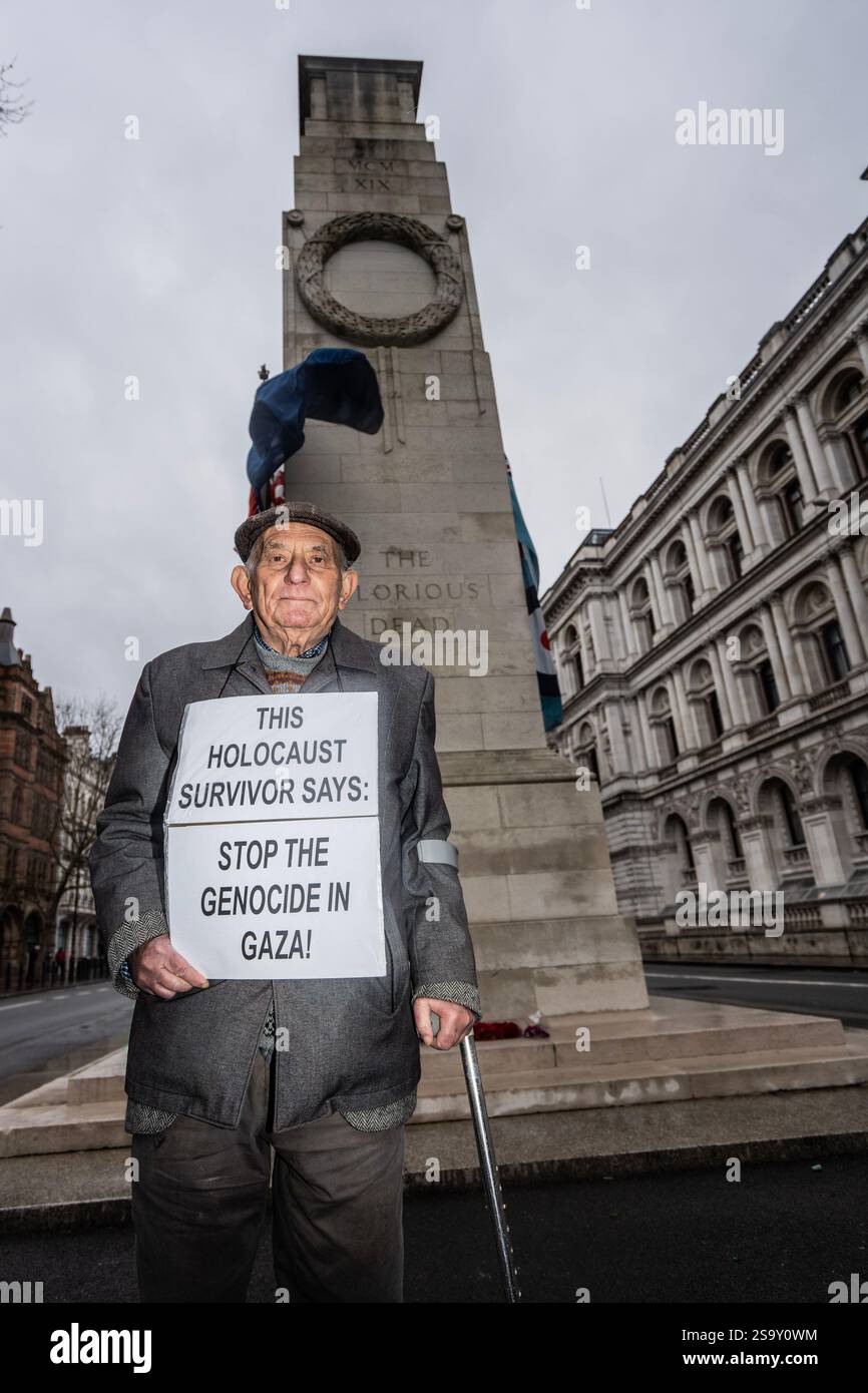 Stephan Kapos, a Holocaust survivor, holds a placard during the demonstration. A small group of London Jews (North London Peaceniks and Jews Against Genocide) have chosen Holocaust Memorial Day to protest against the war in Gaza, drawing parallels between the Nazi genocide at Auschwitz with what they claim is a genocide in Gaza. Actions include laying wreaths at the Cenotaph in central London as well as laying effigies of murdered Palestinian babies at the Kinder-transport sculpture in Liverpool Street station. (Photo by Lab Ky Mo/SOPA Images/Sipa USA) Stock Photo