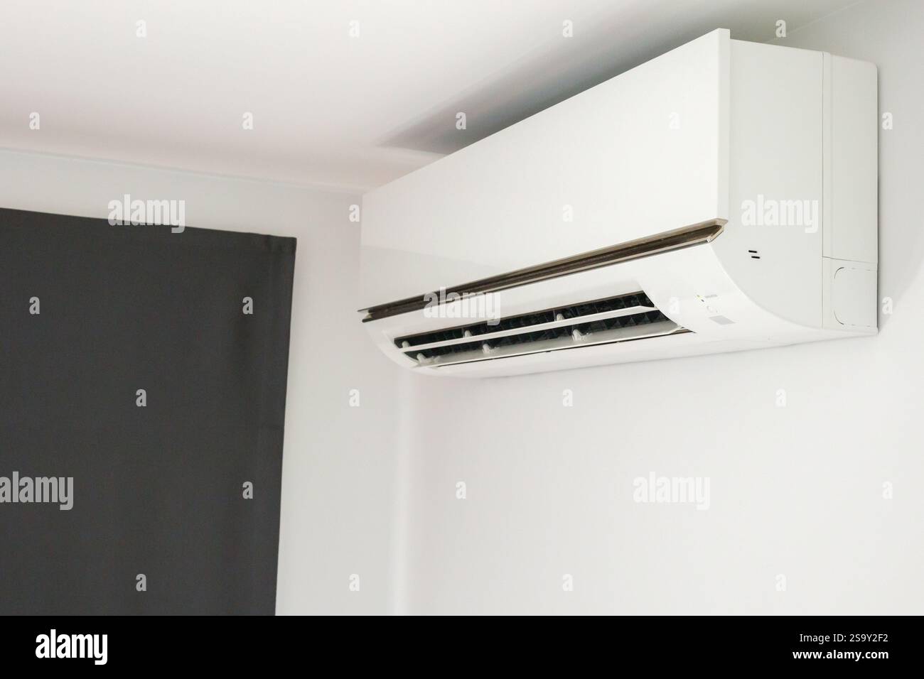 Air conditioner on white wall room interior background Stock Photo - Alamy