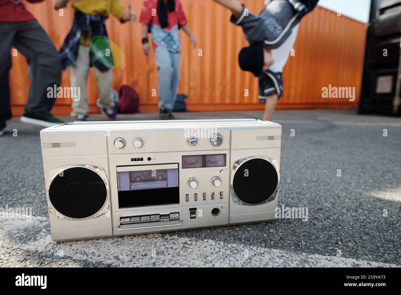 Highlighting Retro Boombox with Dancers in Background Stock Photo