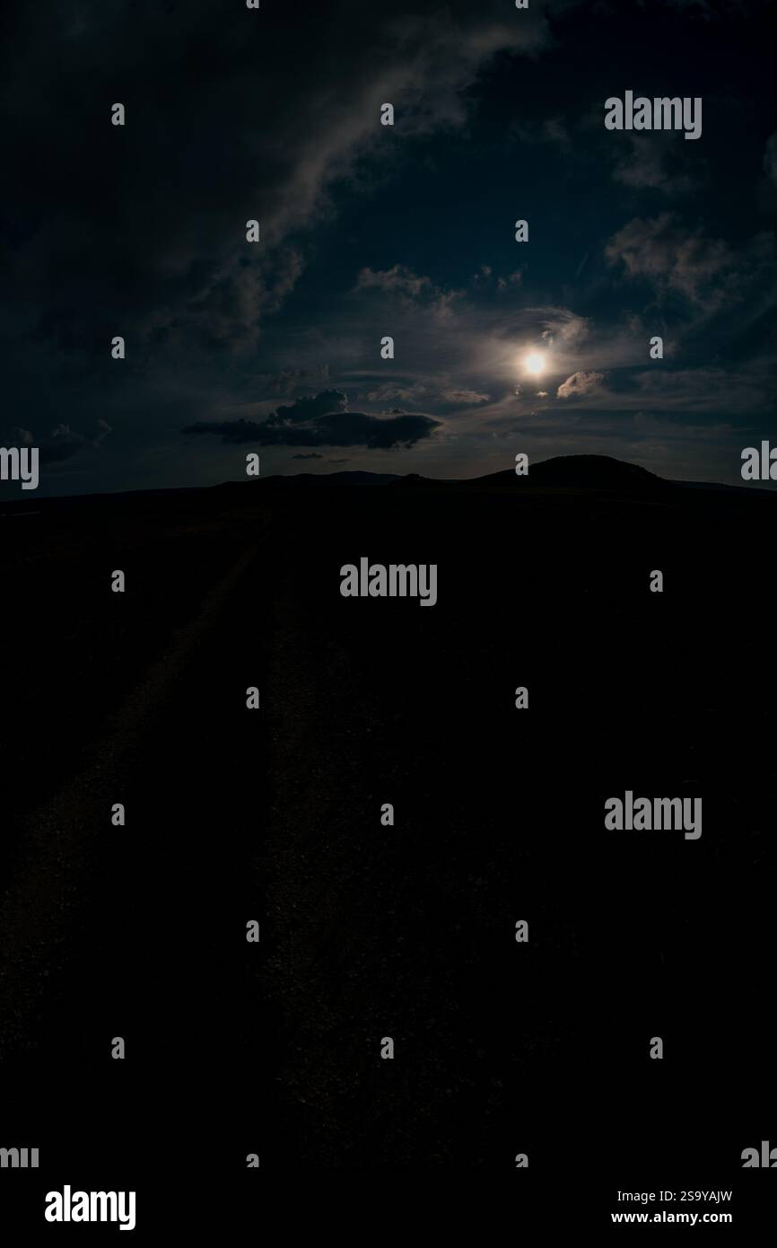 Dirt road under the dark sky hi-res stock photography and images - Alamy