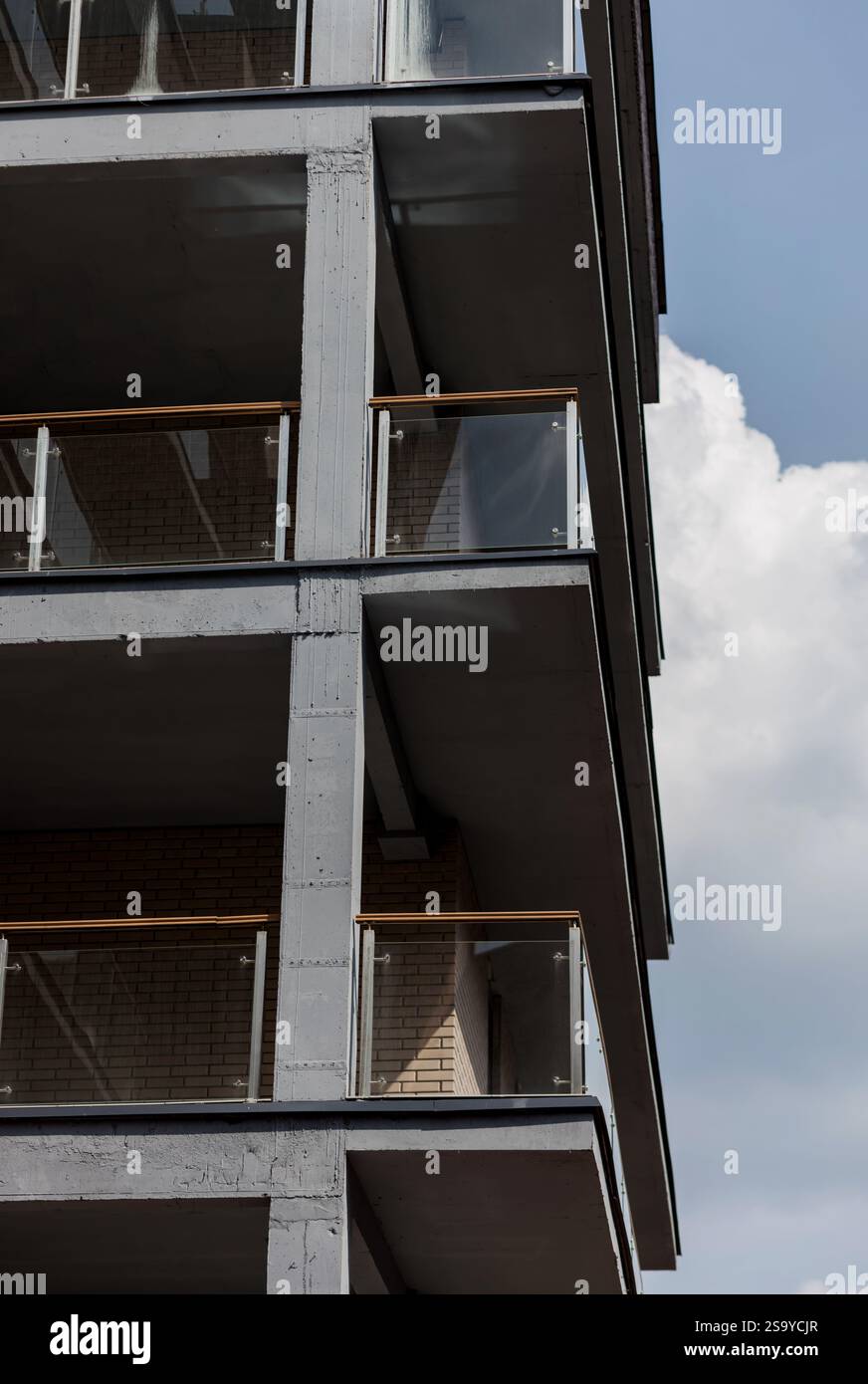 Contemporary apartment building with glass balconies and minimalist ...