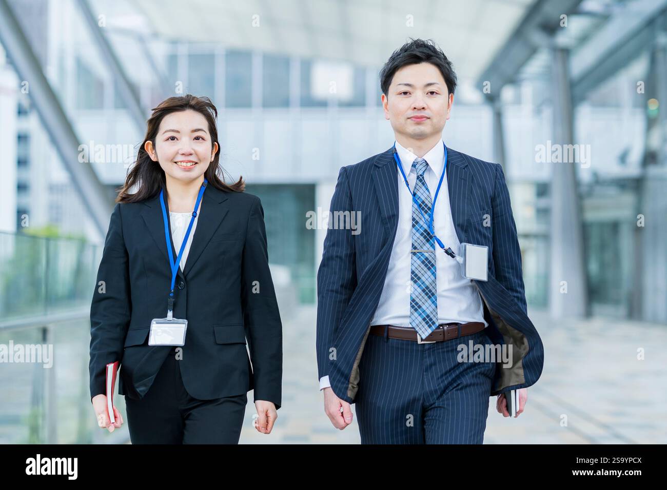 Businessmen and women walking side by side Stock Photo - Alamy