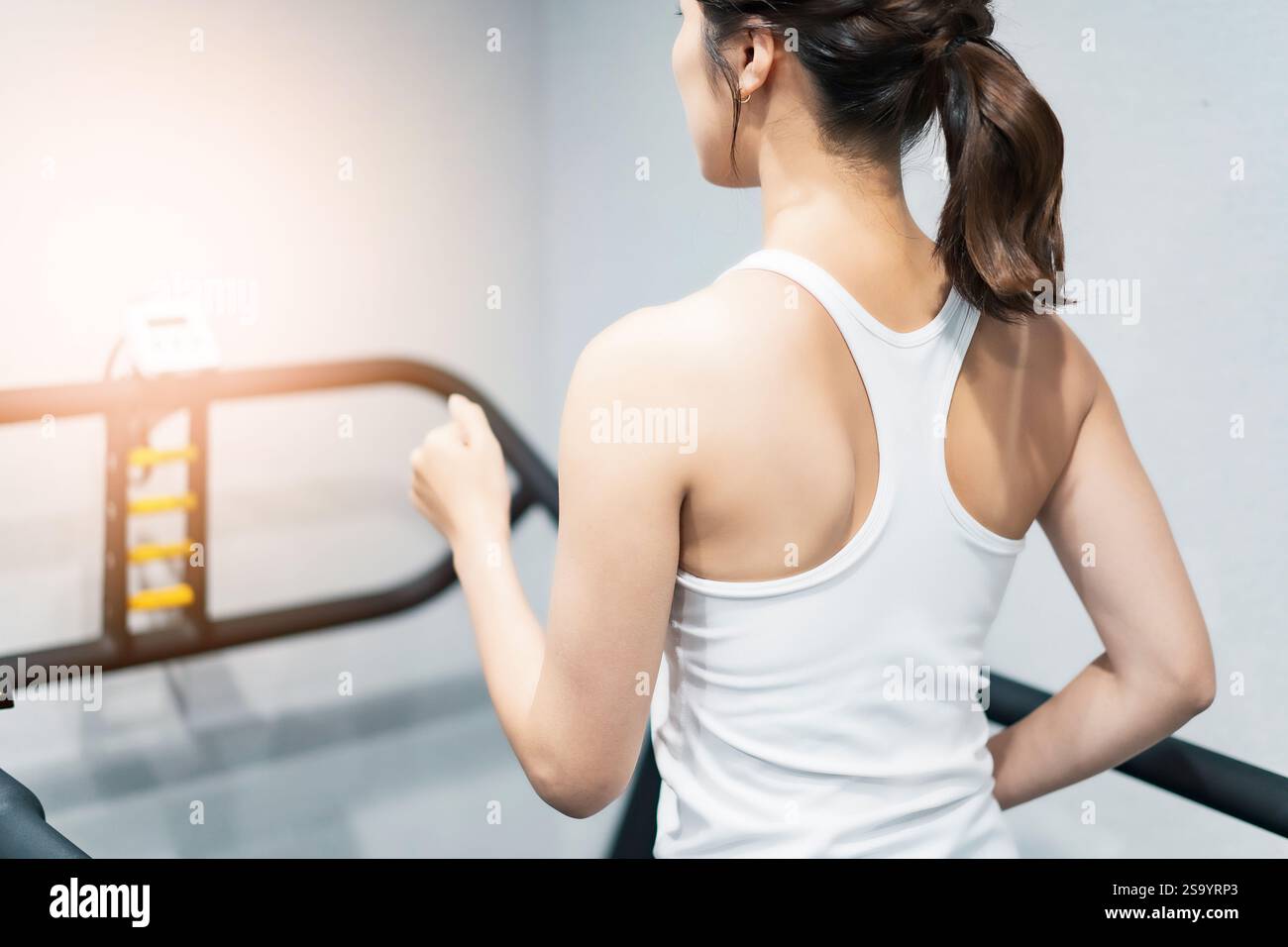 Woman exercising on running machine Stock Photo - Alamy