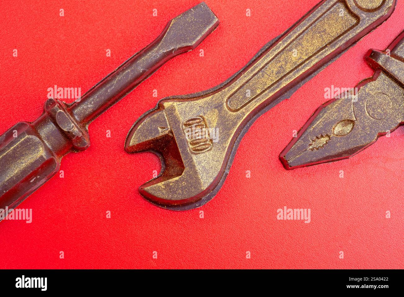 Old rusty pliers isolated on a red background. Stock Photo