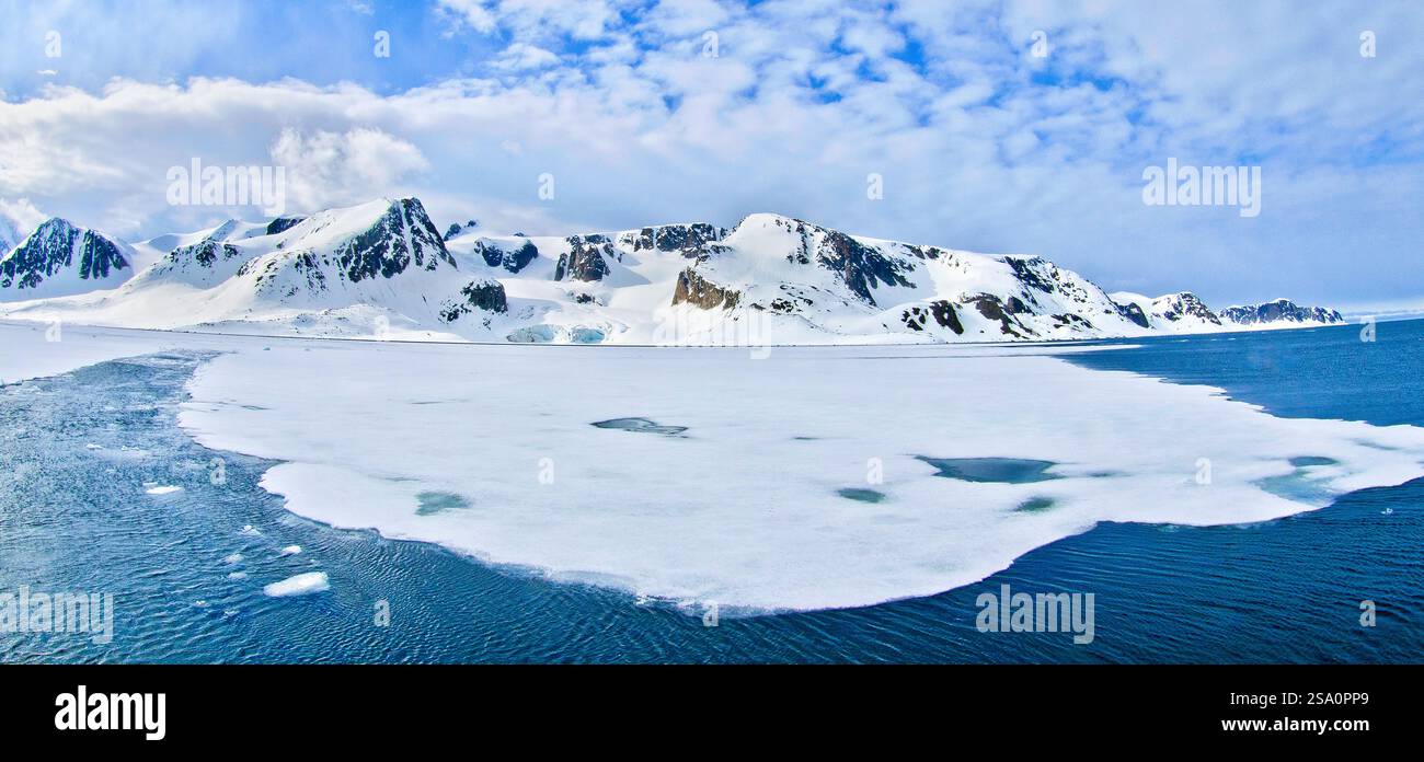 Drift floating Ice and Snowcapped Mountains, Albert I Land, Arctic, Spitsbergen, Svalbard, Norway, Europe Stock Photo
