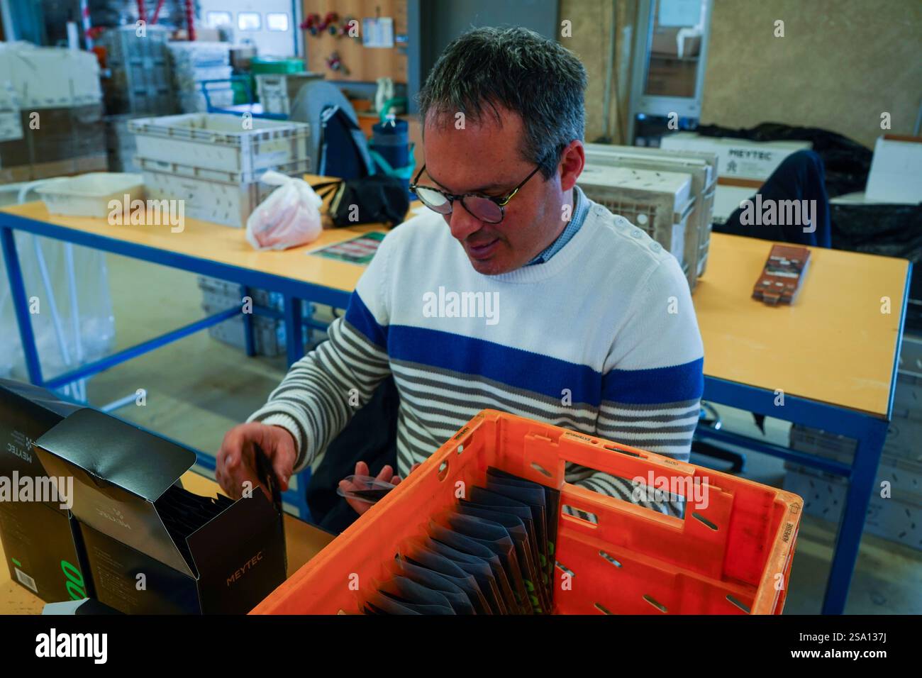 Disabled worker working in the ESAT product packaging workshop ...