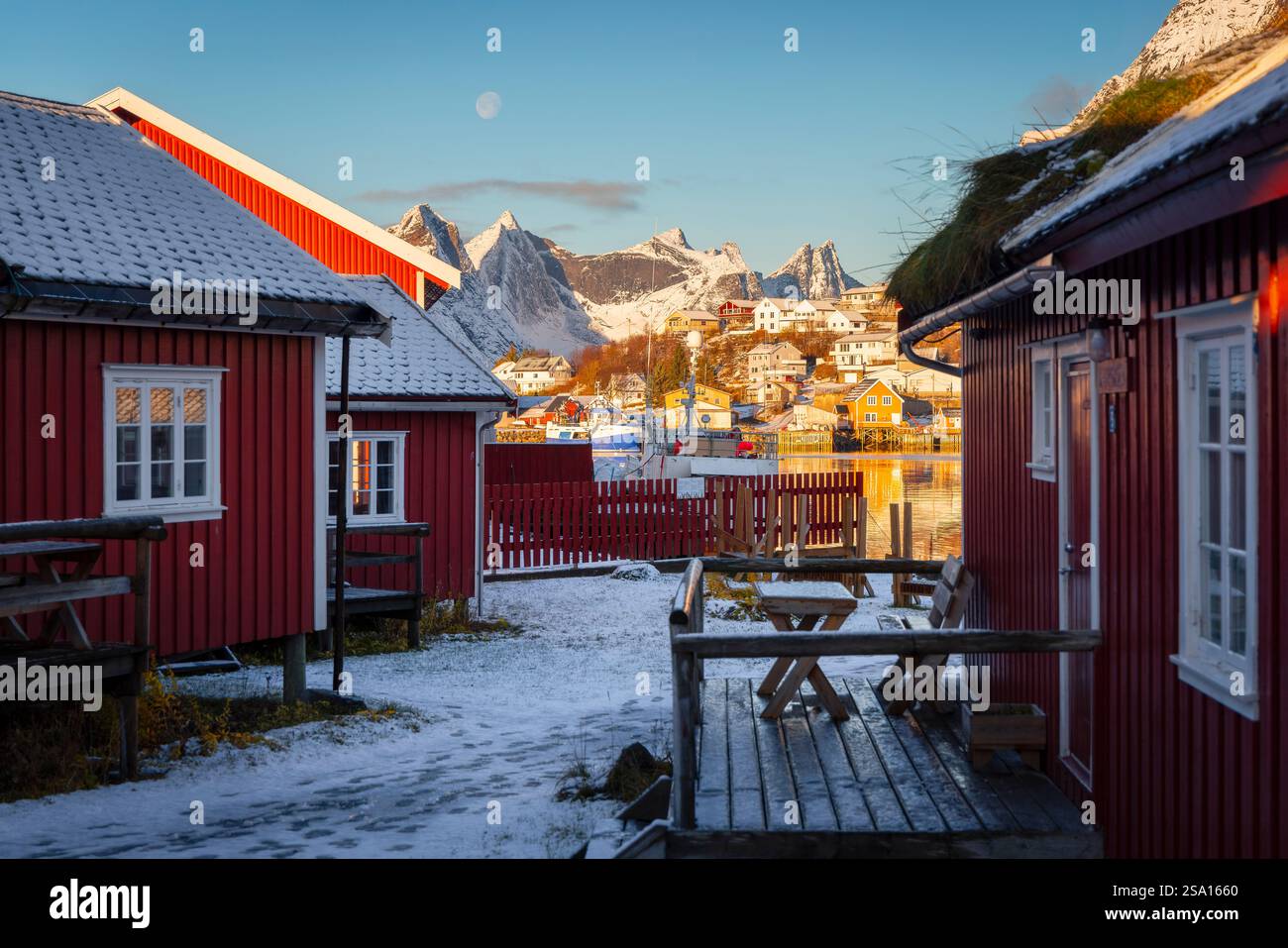 Rorbuer and mountains at Reine during winter sunset, Moskenes, Moskenesoya, Nordland, Lofoten, Norway, Northern Europe Stock Photo