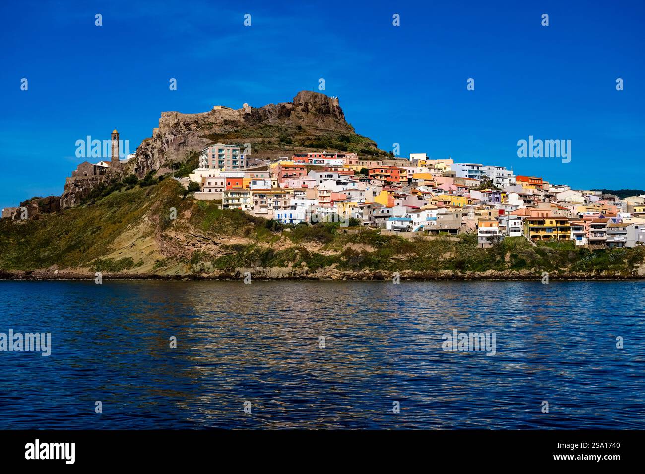 Houses in the coastal town of Castelsardo, grouped around a hill with the Castillo Aragonés, the Aragonese castle. Stock Photo