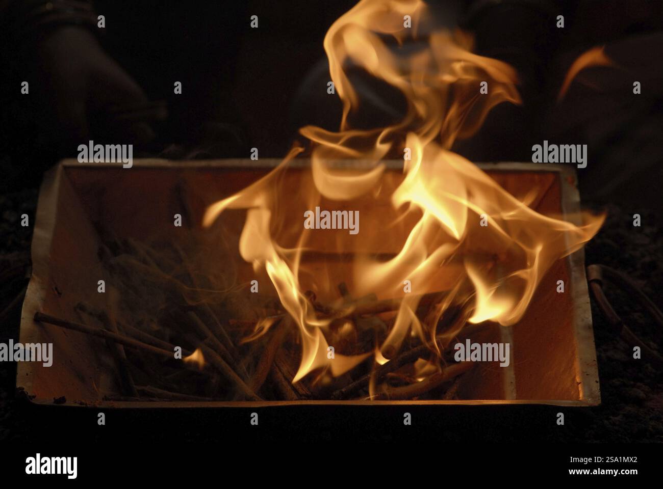 Havan or Homa, igniting sacrificial or ceremonial fire in Copper Square Kunda means container, Hindu worship at Sion, Bombay Mumbai, Maharashtra, Indi Stock Photo