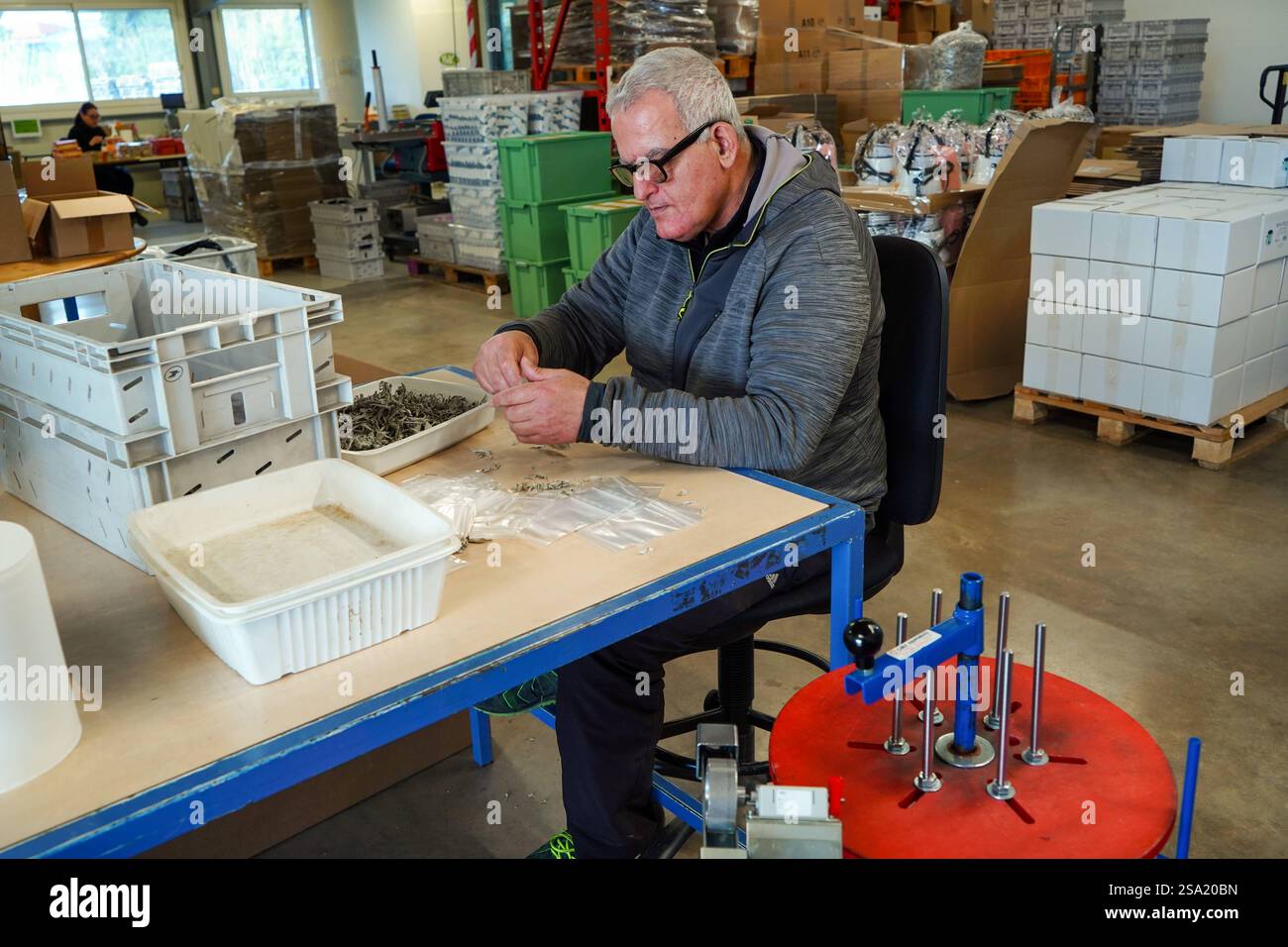 Disabled worker working in the ESAT product packaging workshop ...