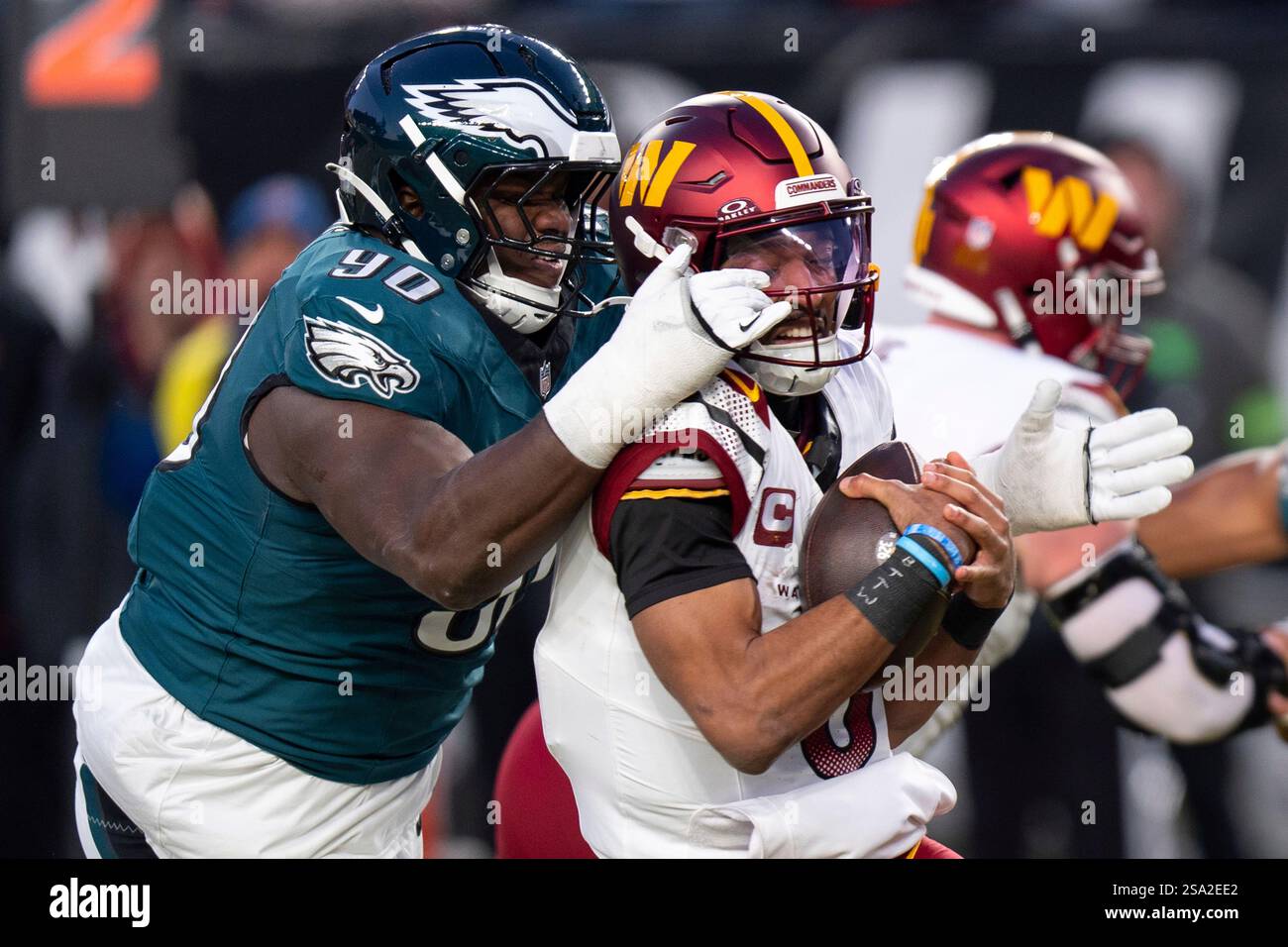 Washington Commanders quarterback Jayden Daniels (5) gets sacked by