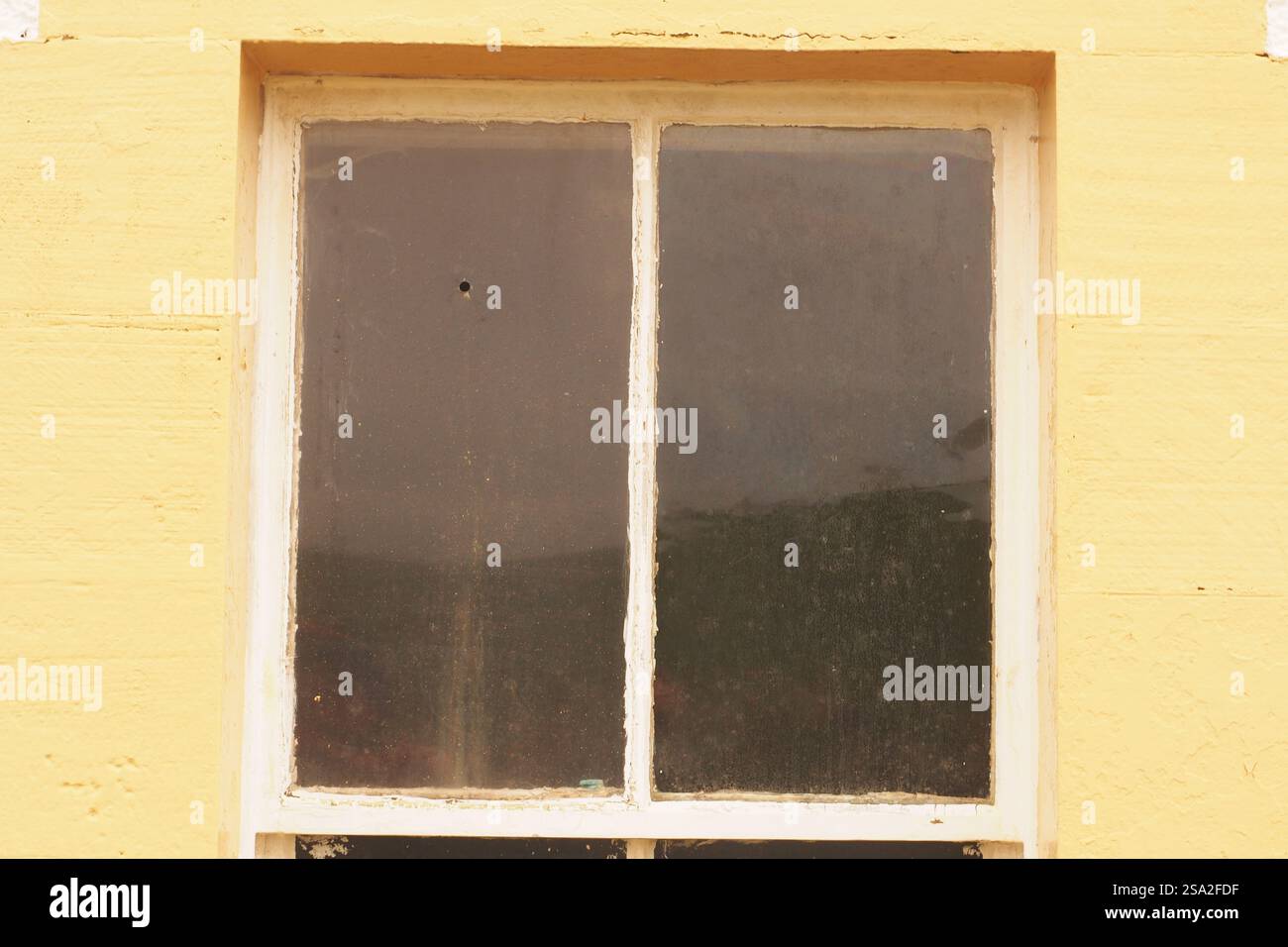 An old window showing an air rifle hole in one of its panes Stock Photo ...