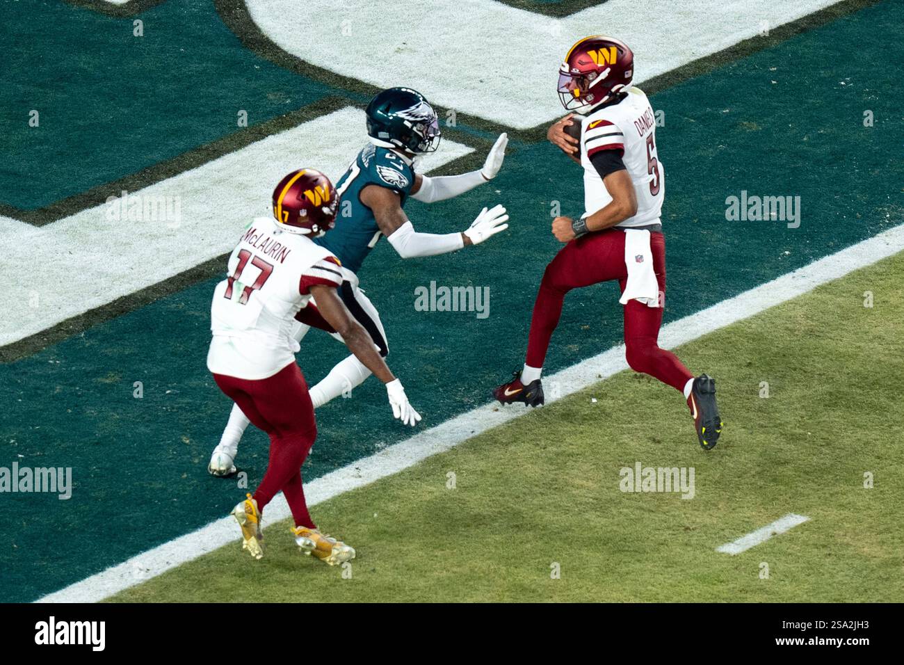 Washington Commanders quarterback Jayden Daniels (5) gets into the end ...