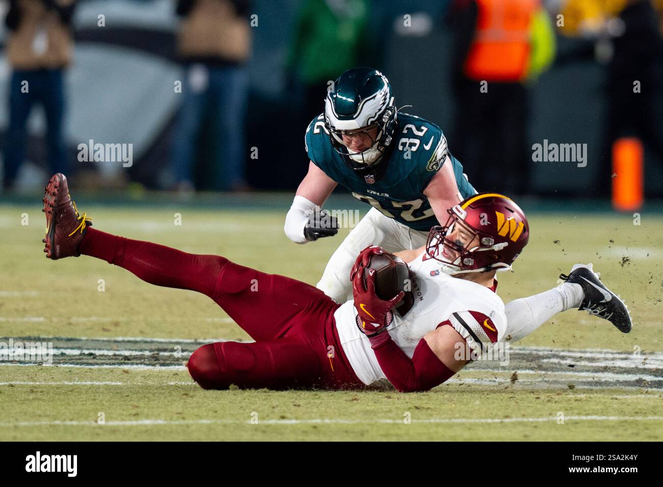 Washington Commanders tight end Zach Ertz (86) with the catch as Philadelphia Eagles safety Reed