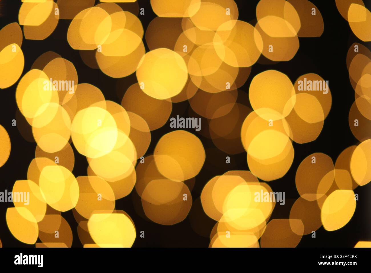 Blurred view of golden lights on dark background. Bokeh effect Stock ...