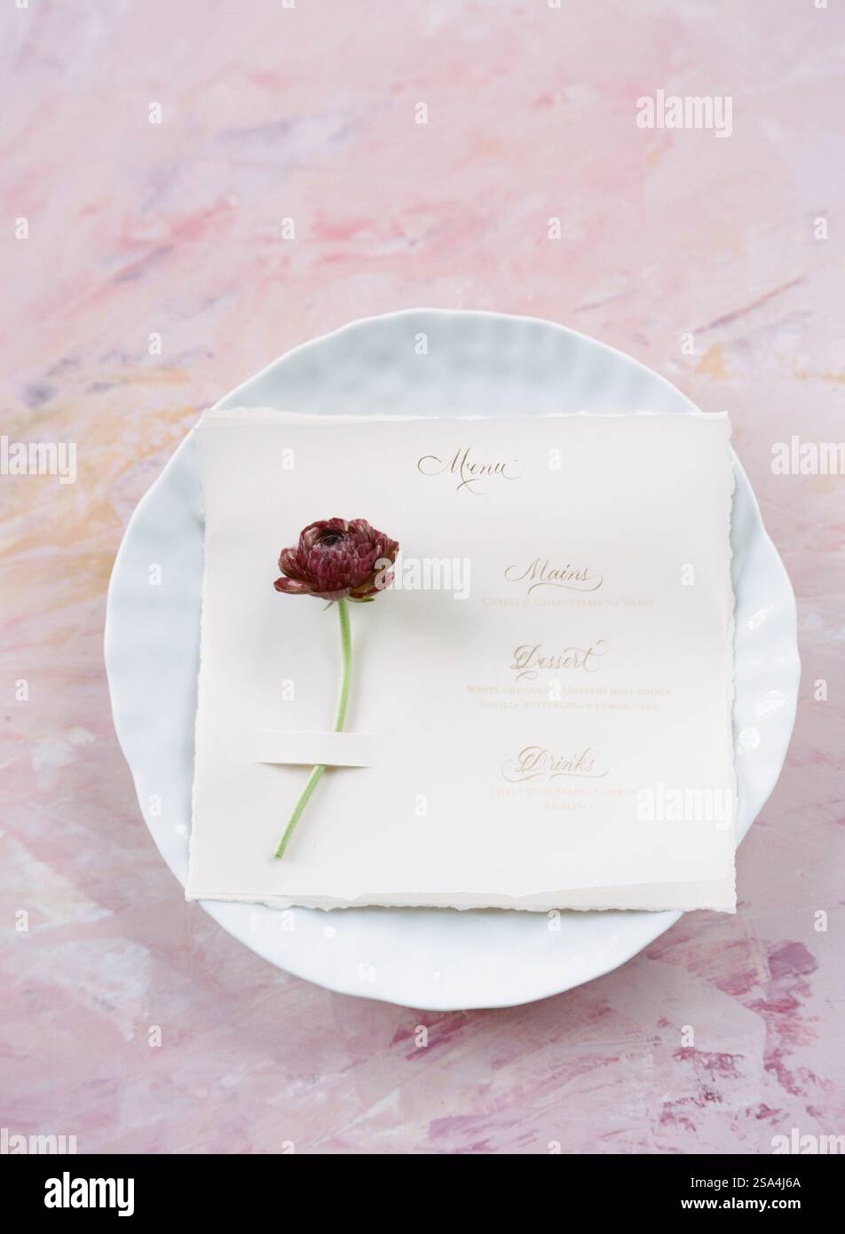 A delicate presentation features a light-colored menu on handmade paper ...