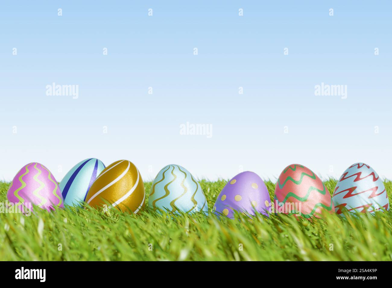 Colorful Easter eggs resting on green grass under a clear sky ...