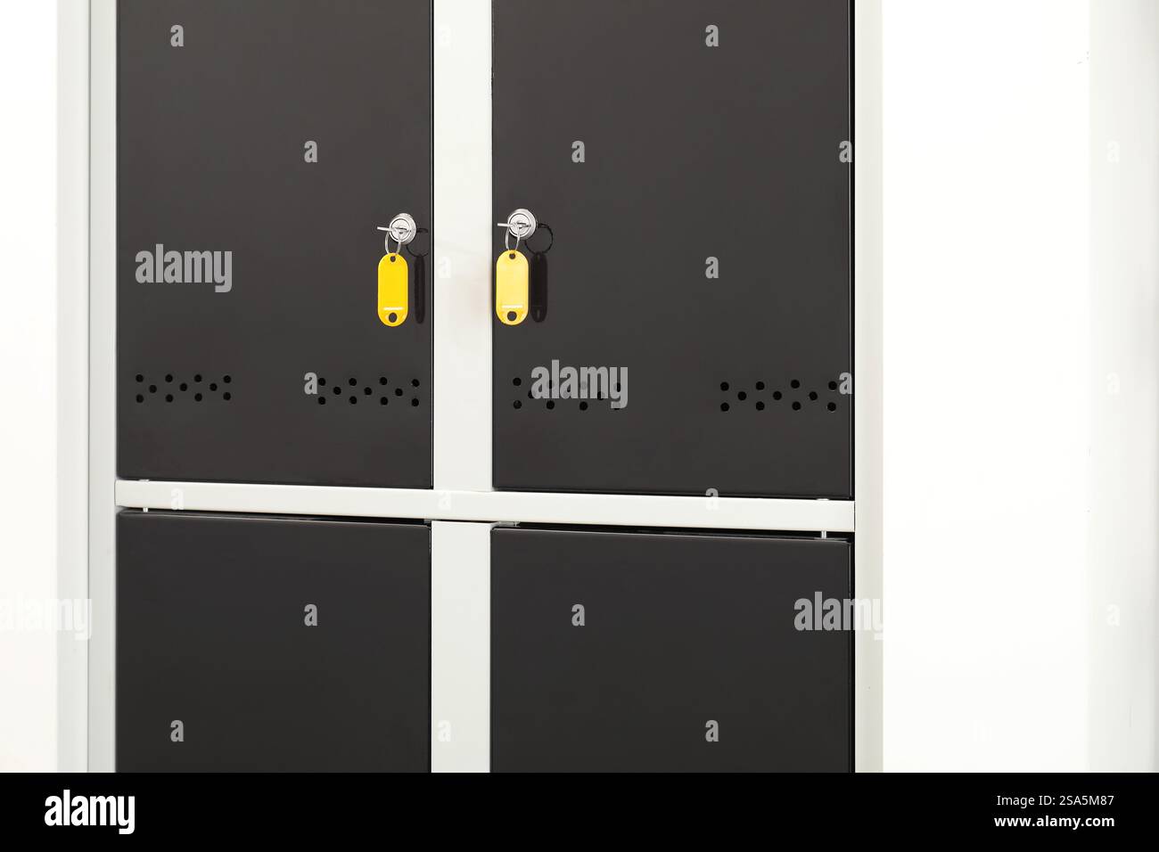 Modern lockers with bright keys indoors, closeup Stock Photo