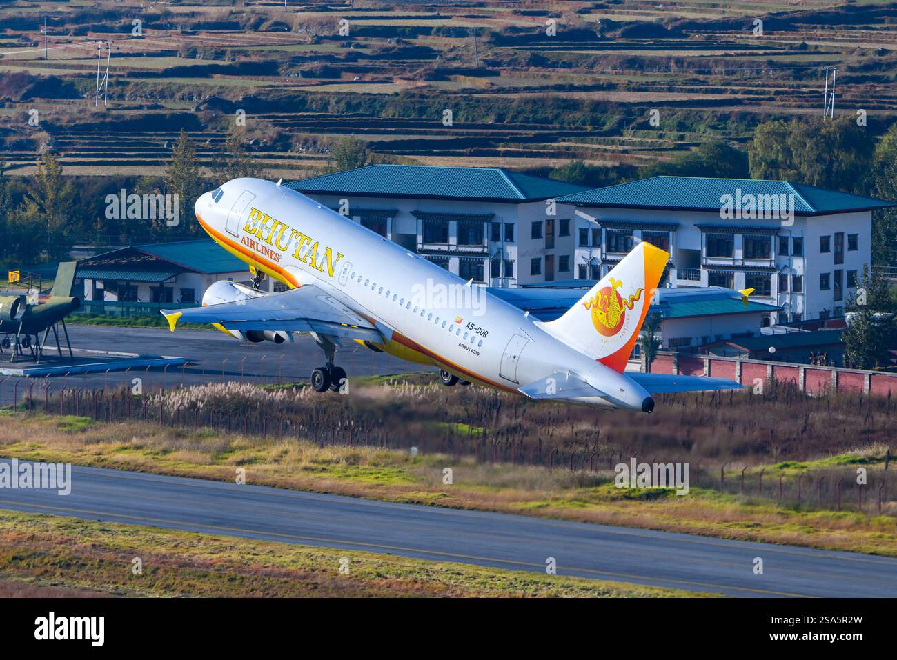 Bhutan Airlines Airbus A319 airplane taking off from Paro Airport in Bhutan. Airline Bhutan Airlines aircraft departing. Stock Photo