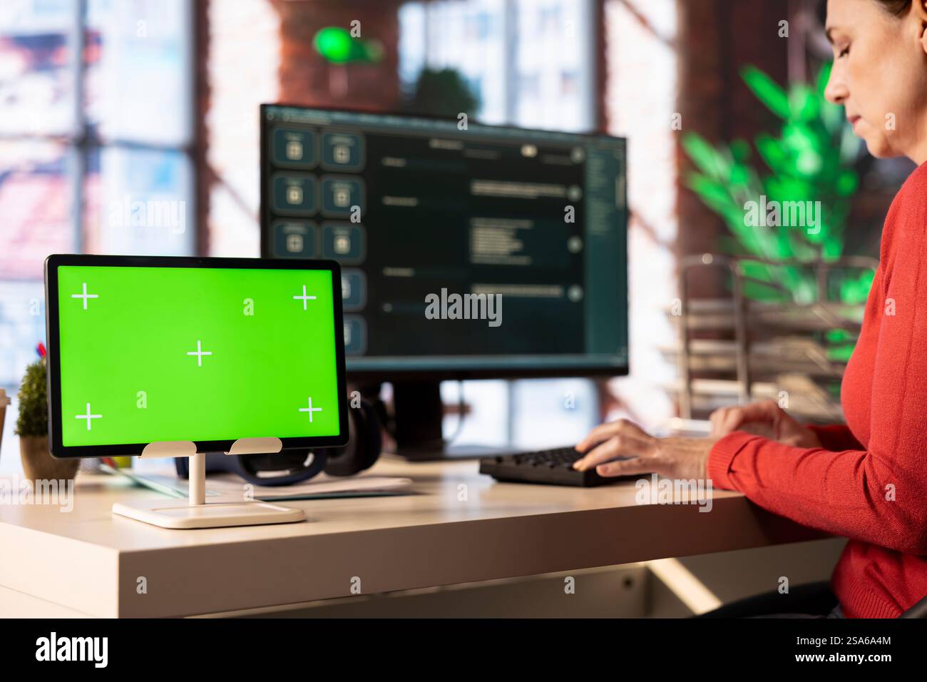 Woman interacting with a futuristic AI tool on pc next to green screen ...