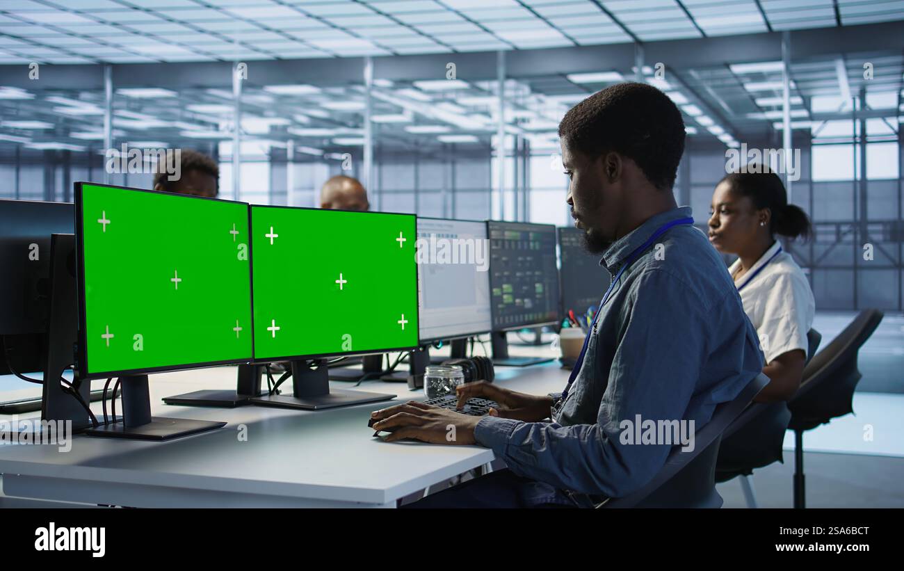 System administrator in server hub ensuring data remains shielded from ...