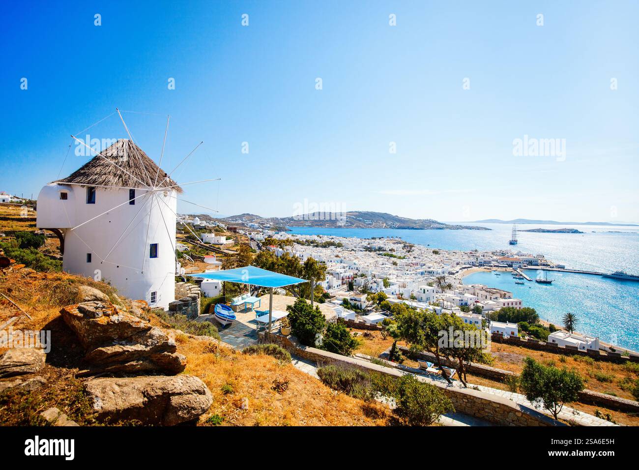 white-greek-windmill-overlooking-traditional-village-on-mykonos-island