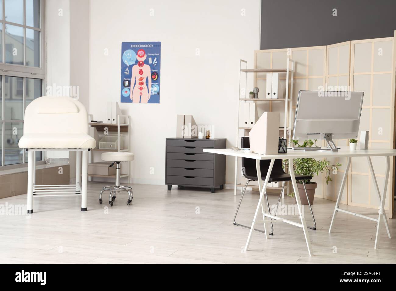 Interior of medical office with doctor's workplace, shelf units and ...