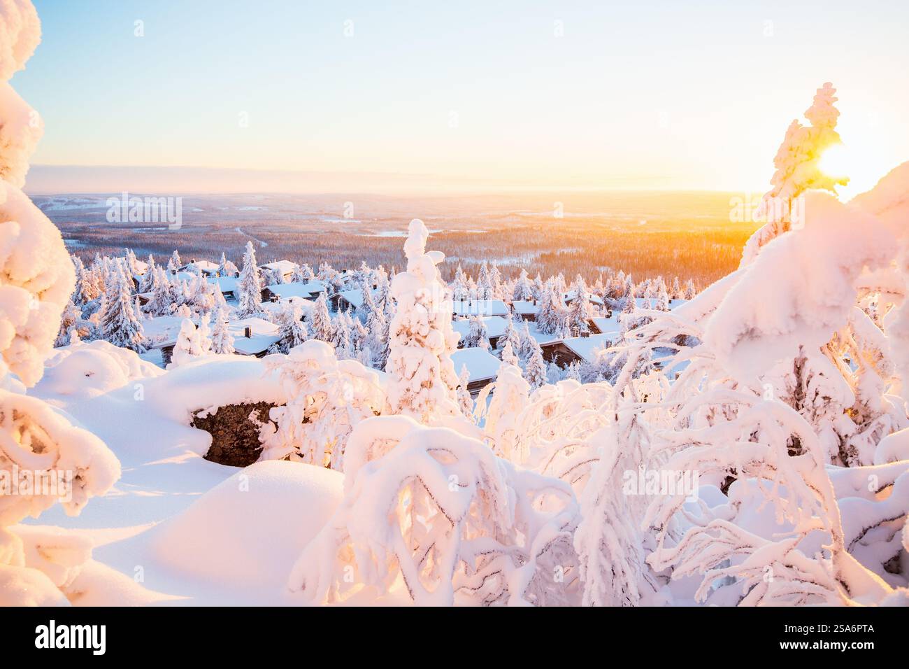 stunning-sunset-view-over-wooden-huts-and-snow-covered-trees-in-finnish