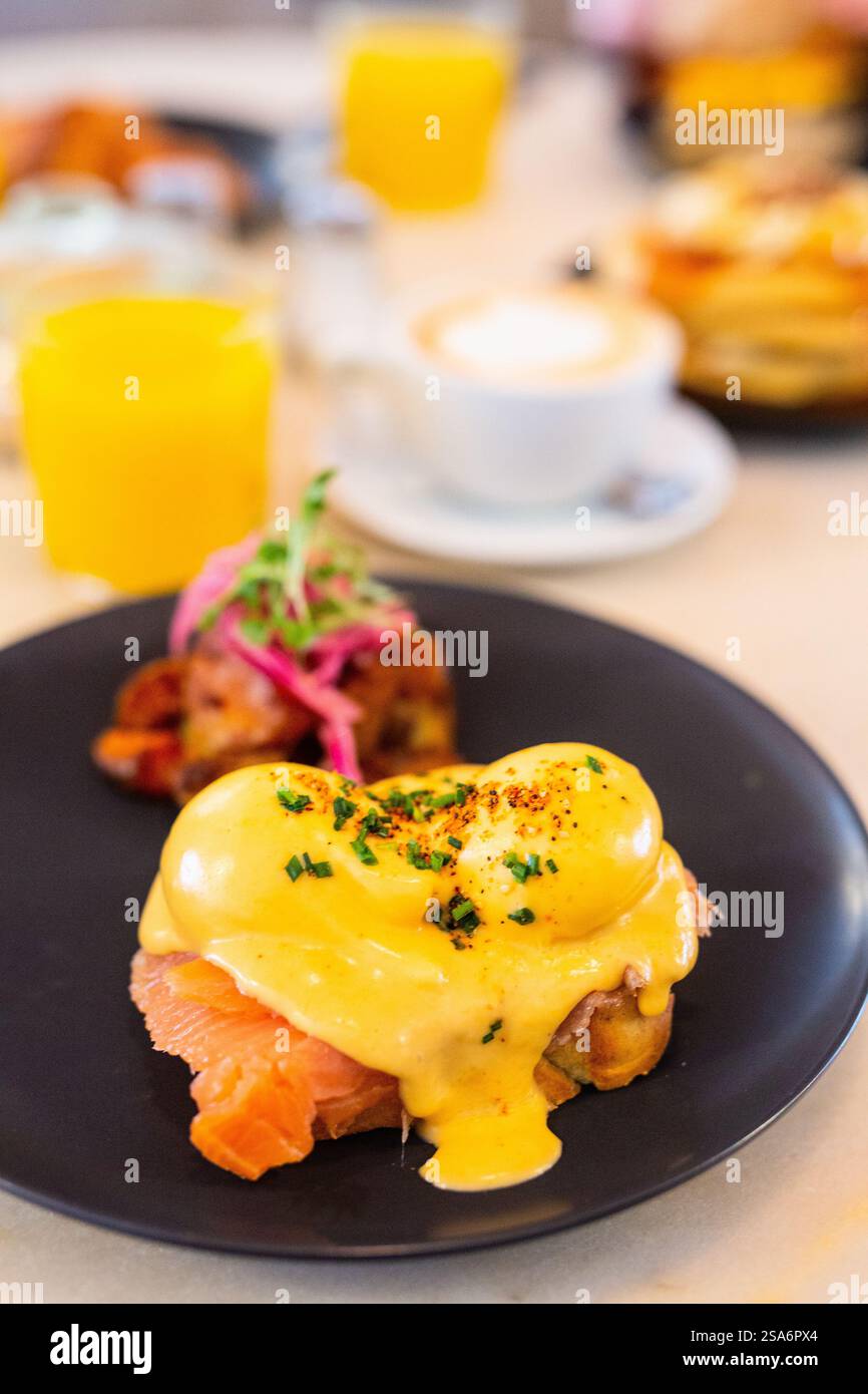 Delicious breakfast with eggs Benedict, vegetables and coffee Stock Photo