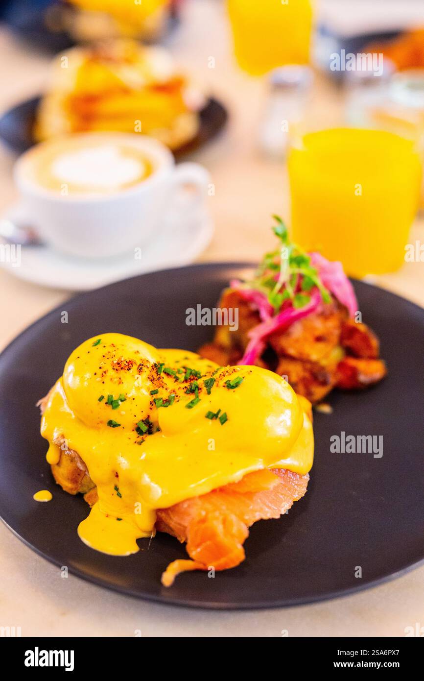 Delicious breakfast with eggs Benedict, vegetables and coffee Stock Photo