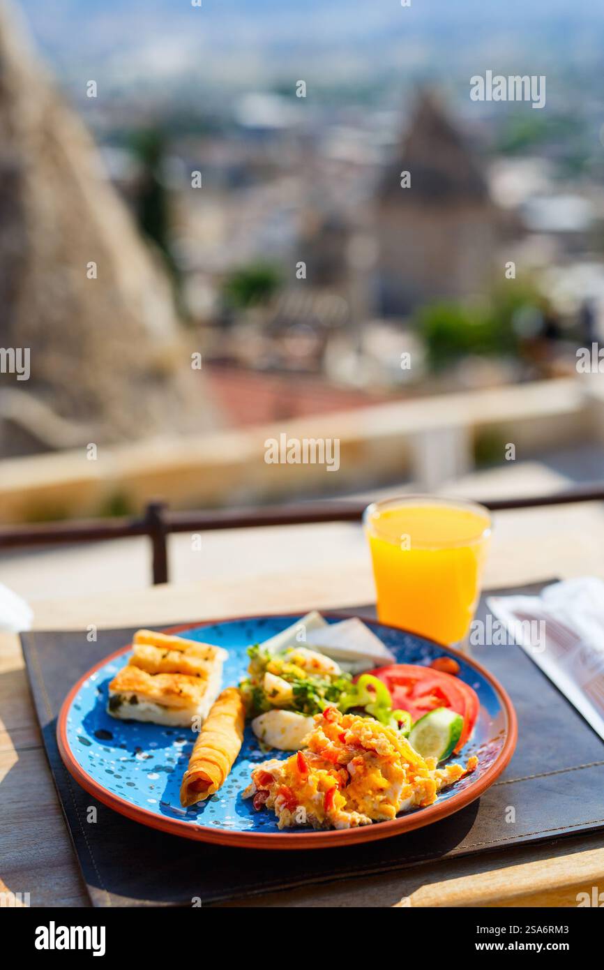 Delicious Turkish breakfast with scrambled eggs served outdoors Stock Photo