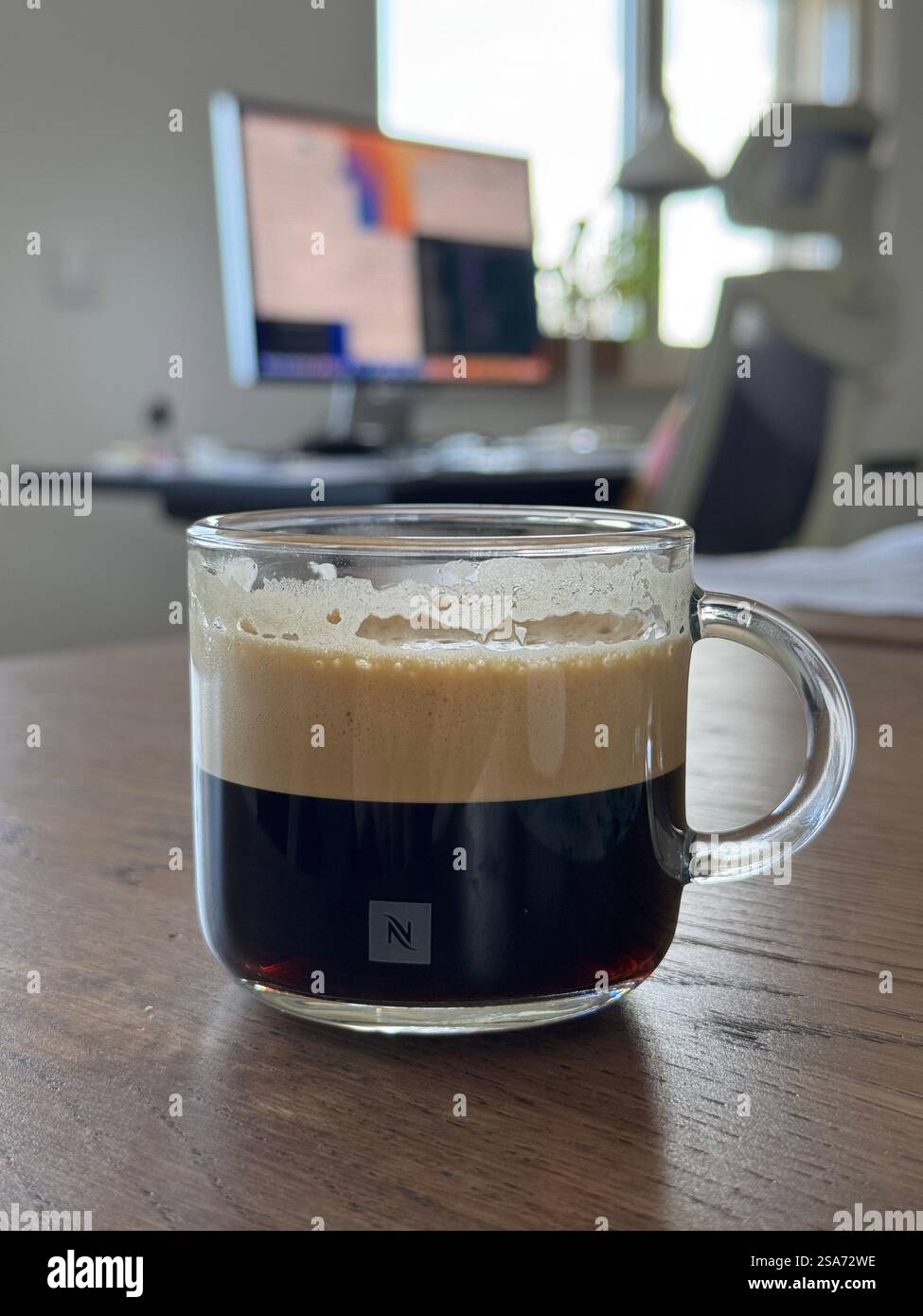 Relaxing while taking a coffee break from remote working - Smartphone Captured Stock Image