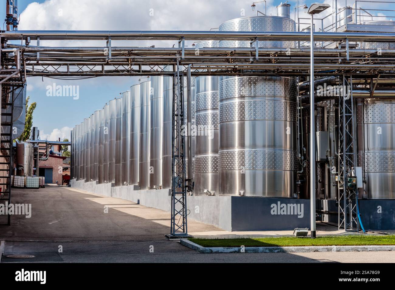 A large industrial plant with many tanks and pipes. The tanks are ...